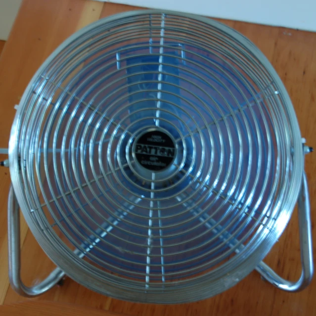 this is an old - fashioned fan on top of a wooden floor