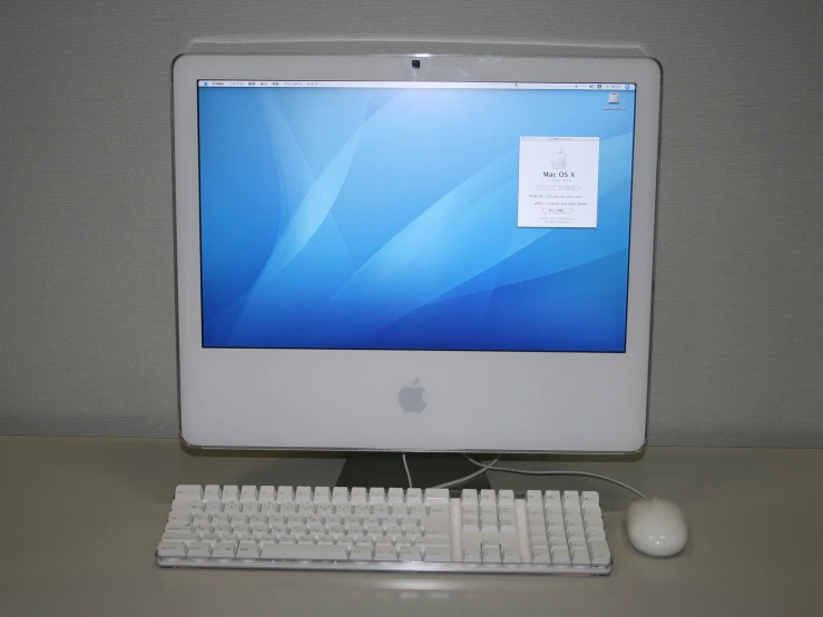 apple computer monitor, keyboard and mouse on table