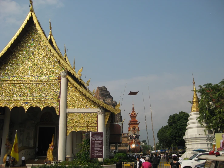 people walking down a street next to an elaborate building