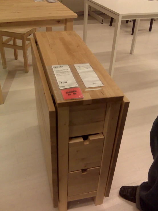 a wooden desk with two papers attached to it