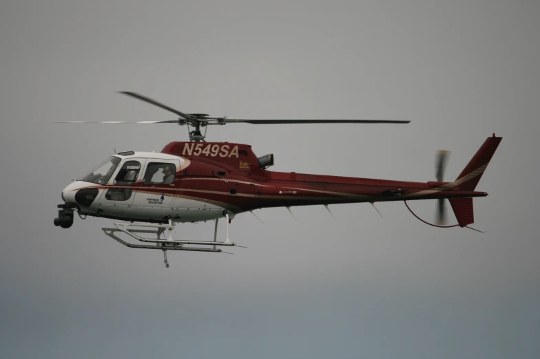 a helicopter flying high in the air with a person inside