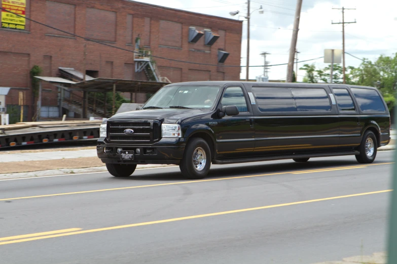 a black limo is driving down the street