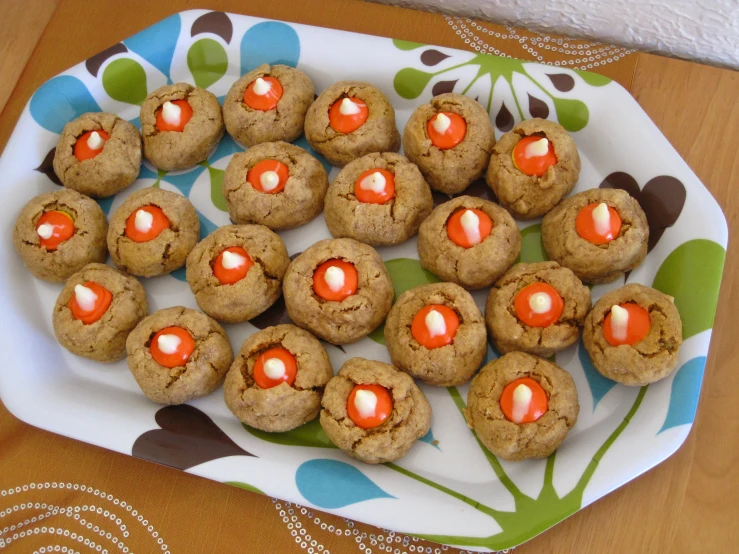 an arrangement of cookies are displayed on a plate