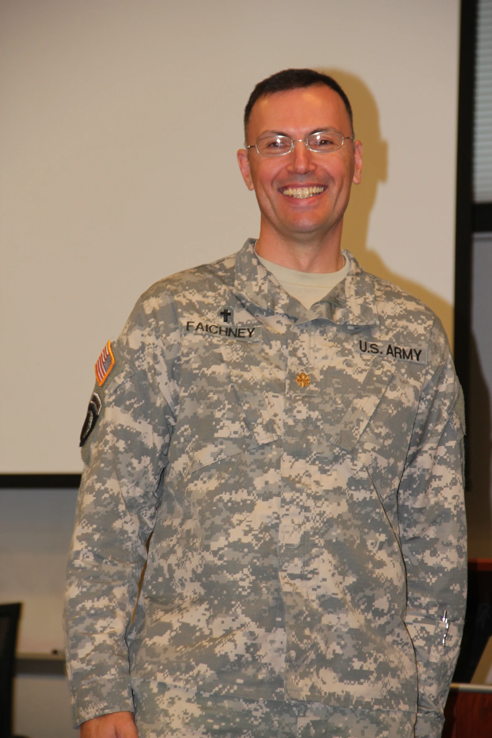 a man in a camo jacket smiling for the camera