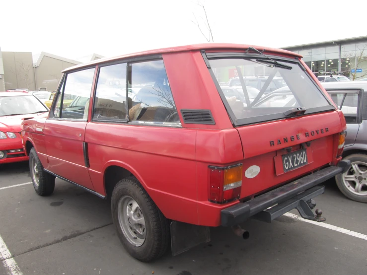 a red pick up truck parked in a parking lot