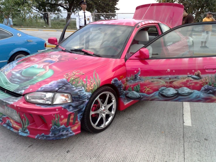 a car is painted in different colors and has fish on it