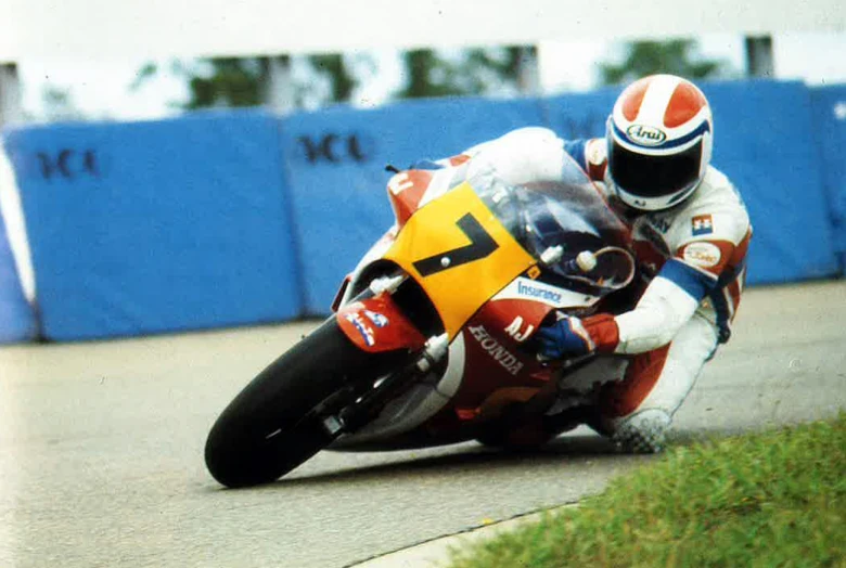 motorcycle driver leaning forward taking a tight turn