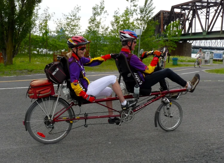 two young women riding on a tandem bike