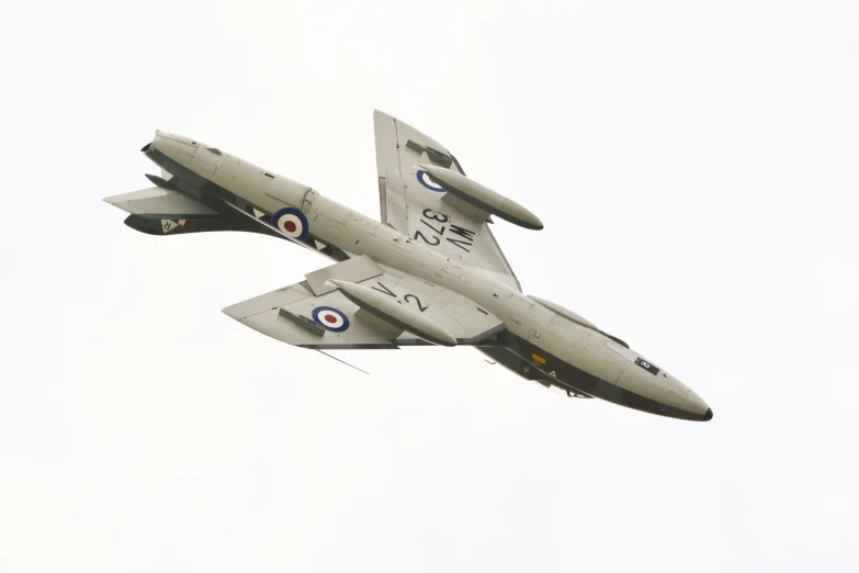 a fighter jet flying in the air on a sunny day