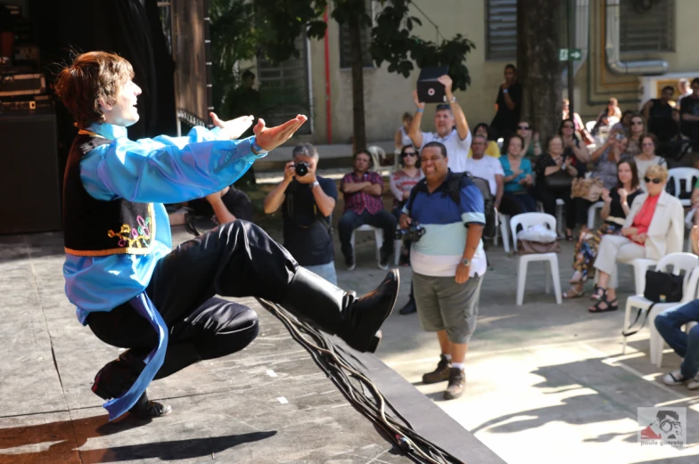 a man doing a trick with a skateboard at a public gathering