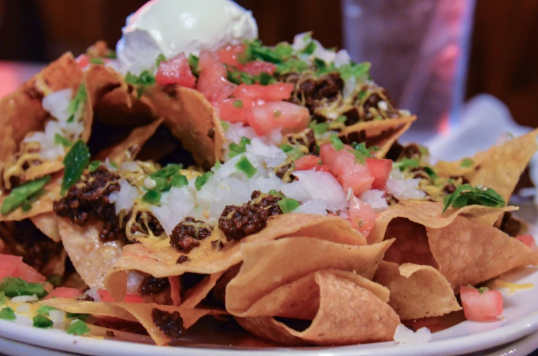 some nachos that are topped with onions and salsa