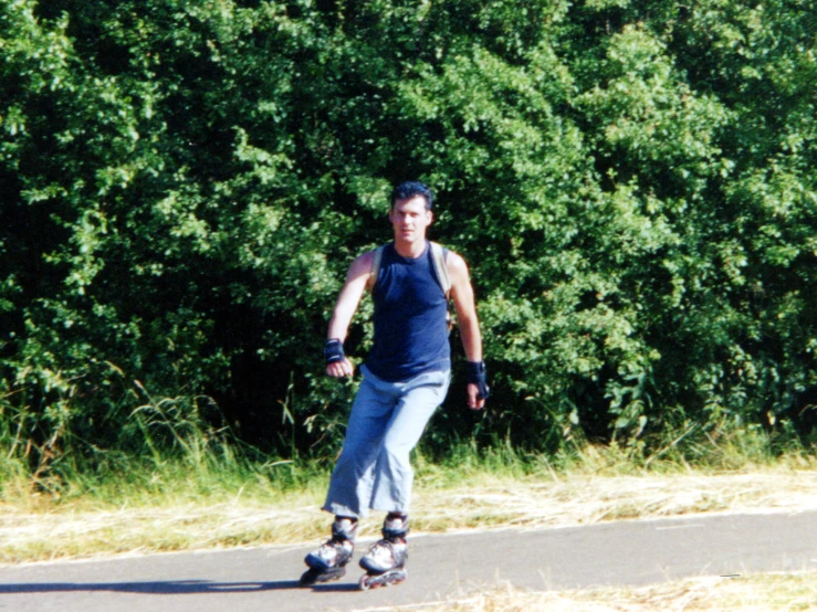 a man is riding his skateboard down the road