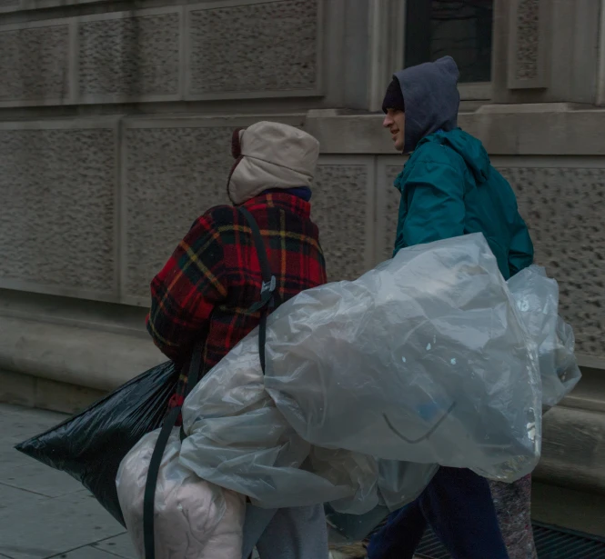 a couple of people walking with shopping bags