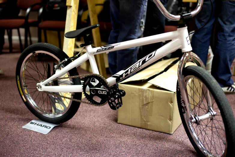 a white bicycle parked inside of a box