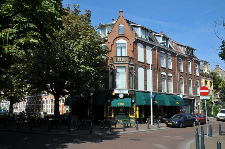 a large brick building with a green awning