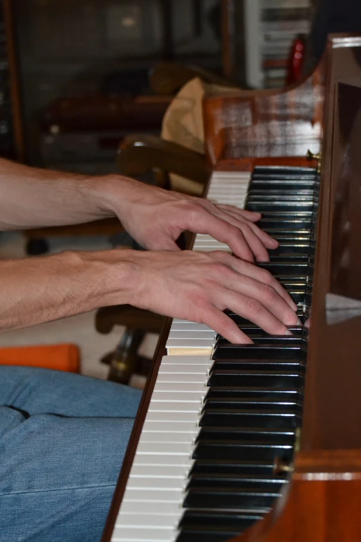 a man holding his hands over the edge of an organ