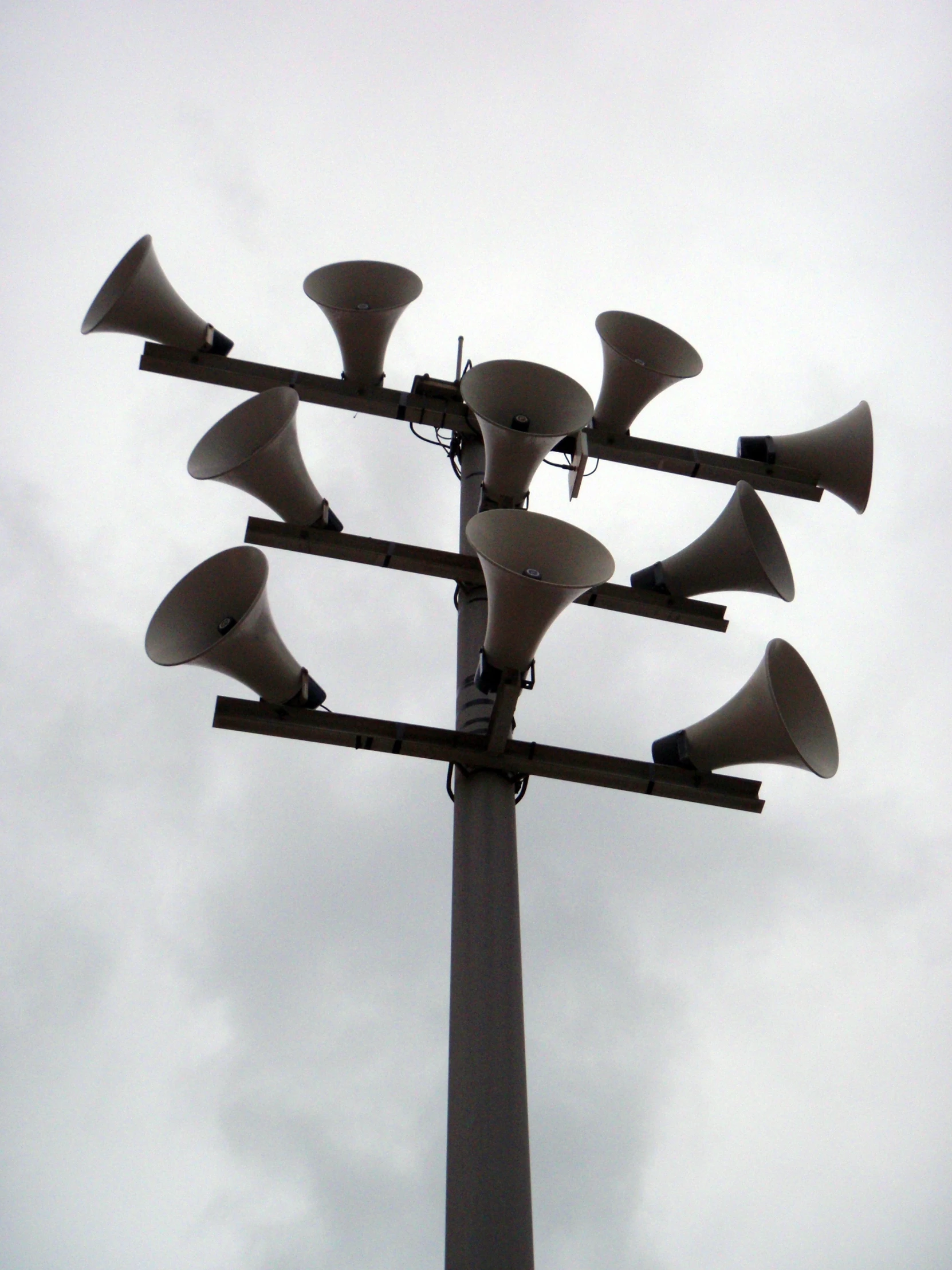 a tall pole with several lightening devices on top