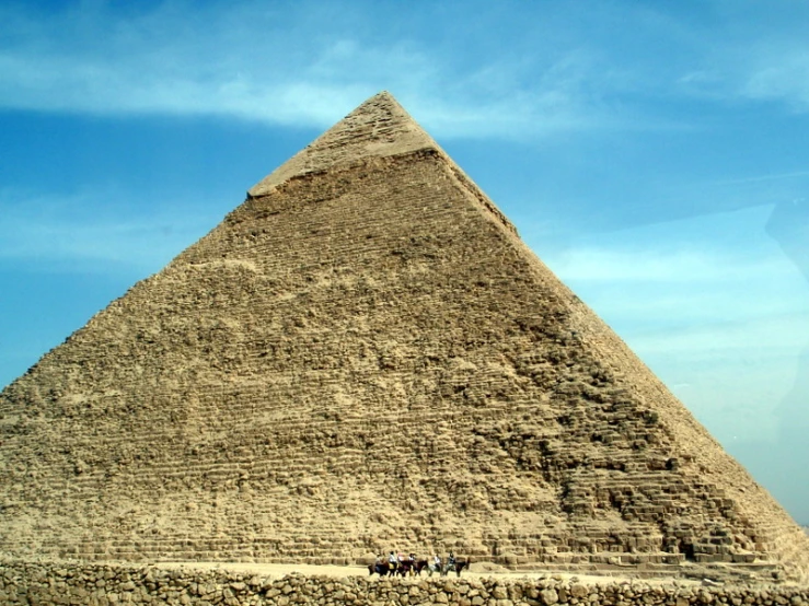a tall pyramid stands on a sunny day