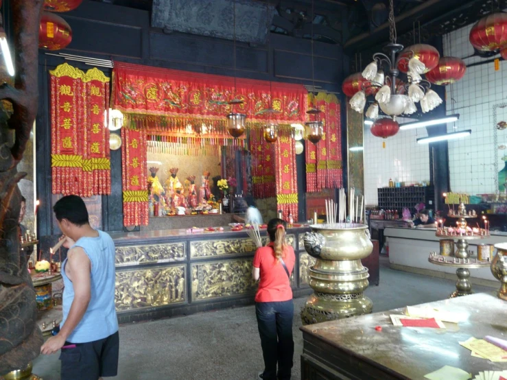 two people are looking at items at an altar