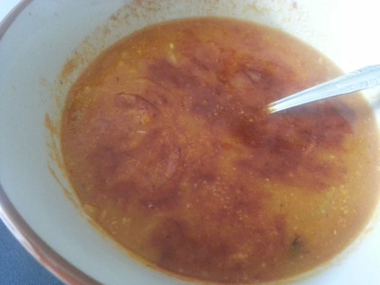 a close up of a bowl of food with a spoon