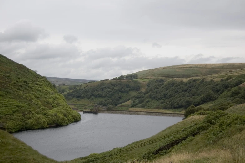 a big lake surrounded by green mountains