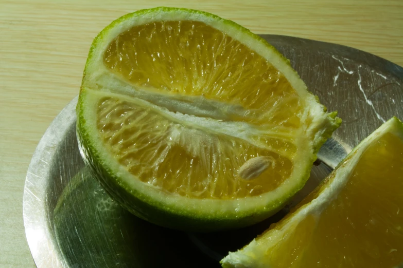 a small silver plate filled with a piece of lime