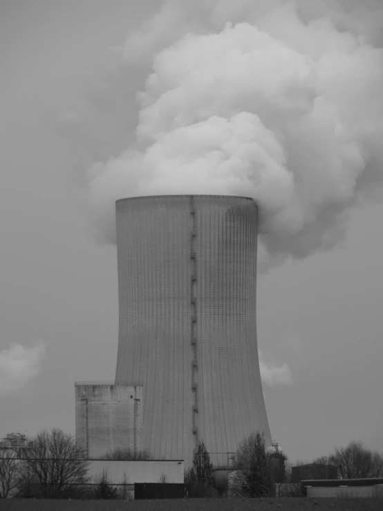 there is smoke billowing out the top of the cooling plant