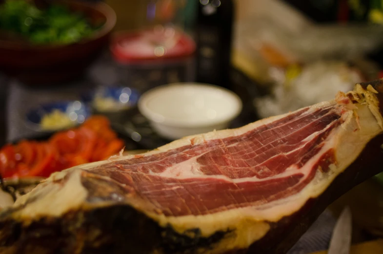 a slice of meat in front of various different types of food