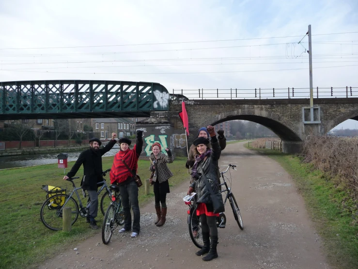 several people that are standing on bikes in the street