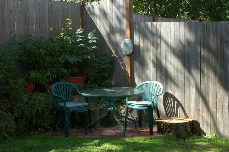 there is an outside table and chairs in the yard