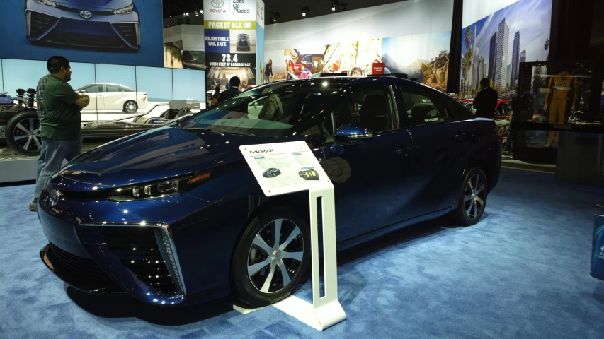 this blue toyota vehicle is on display at an auto show