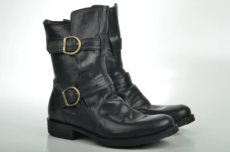 the front view of a womens black boot with double buckles