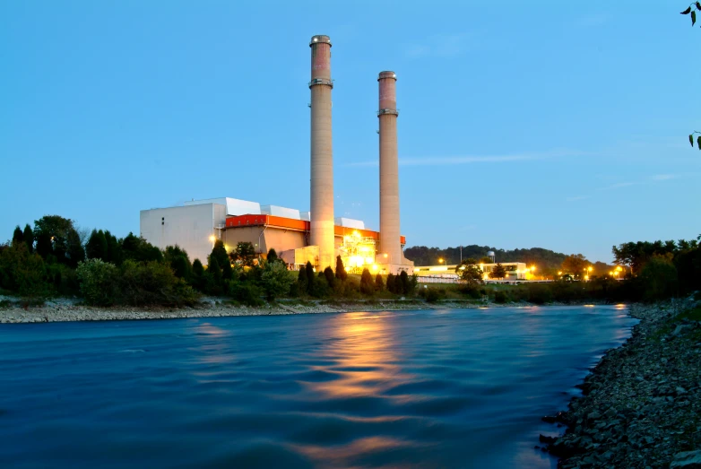 a body of water with two large tall towers in the distance