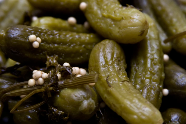 some green pickles and other vegetables on a table