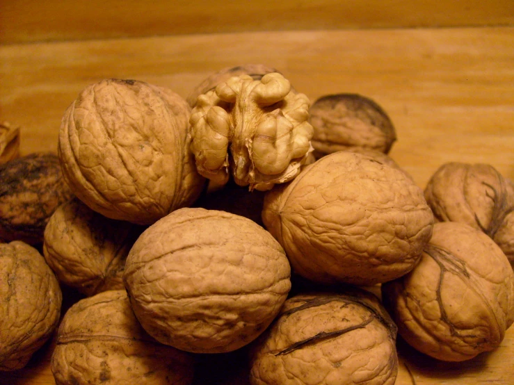 walnuts on the table next to an apple