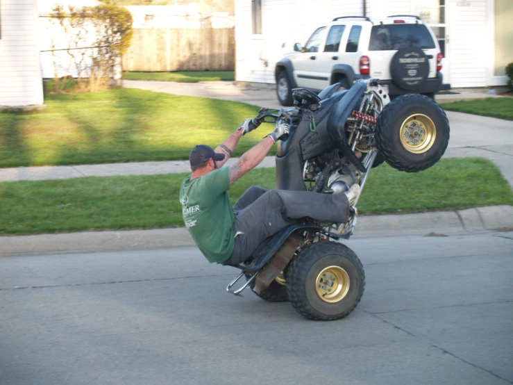 a guy falling off the back of an atv