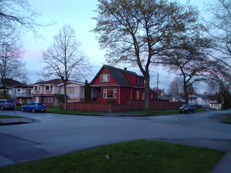 a street corner with a house on the corner