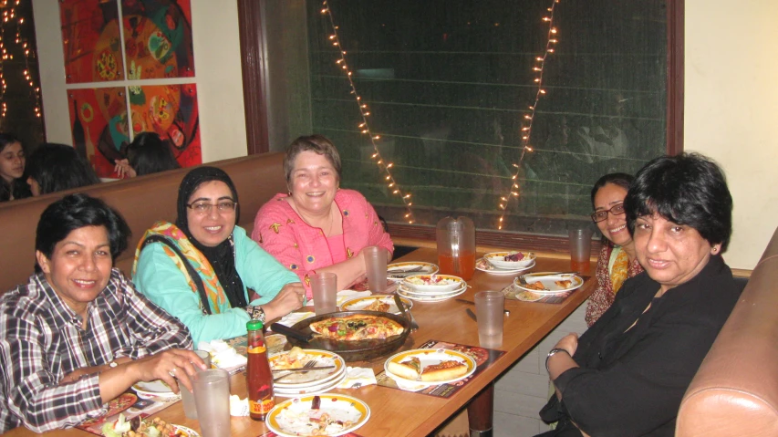 four women at the table having dinner