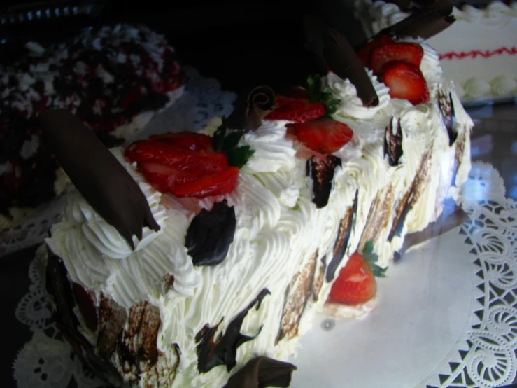 an elegant cake with strawberries on top is cut in half