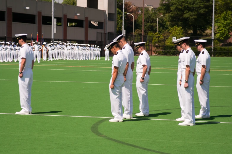 the men in uniform are talking on the field