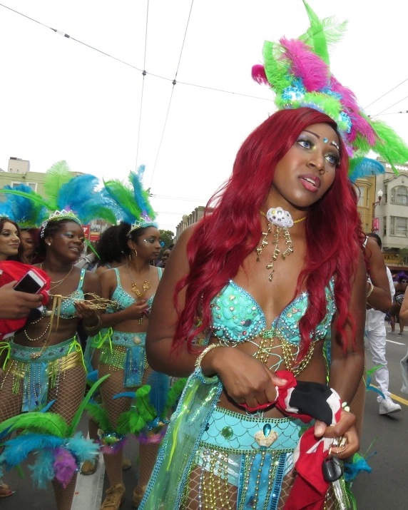 a woman with long red hair and a bodysuit in a parade