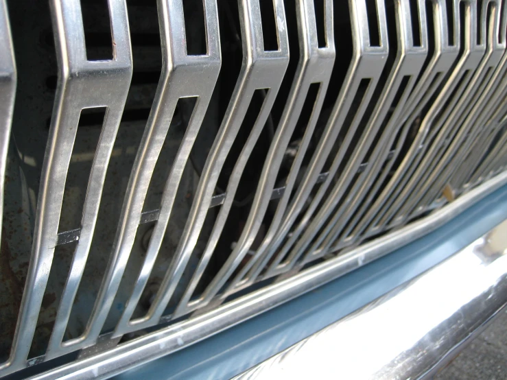 a close - up of grill on a car in sunlight