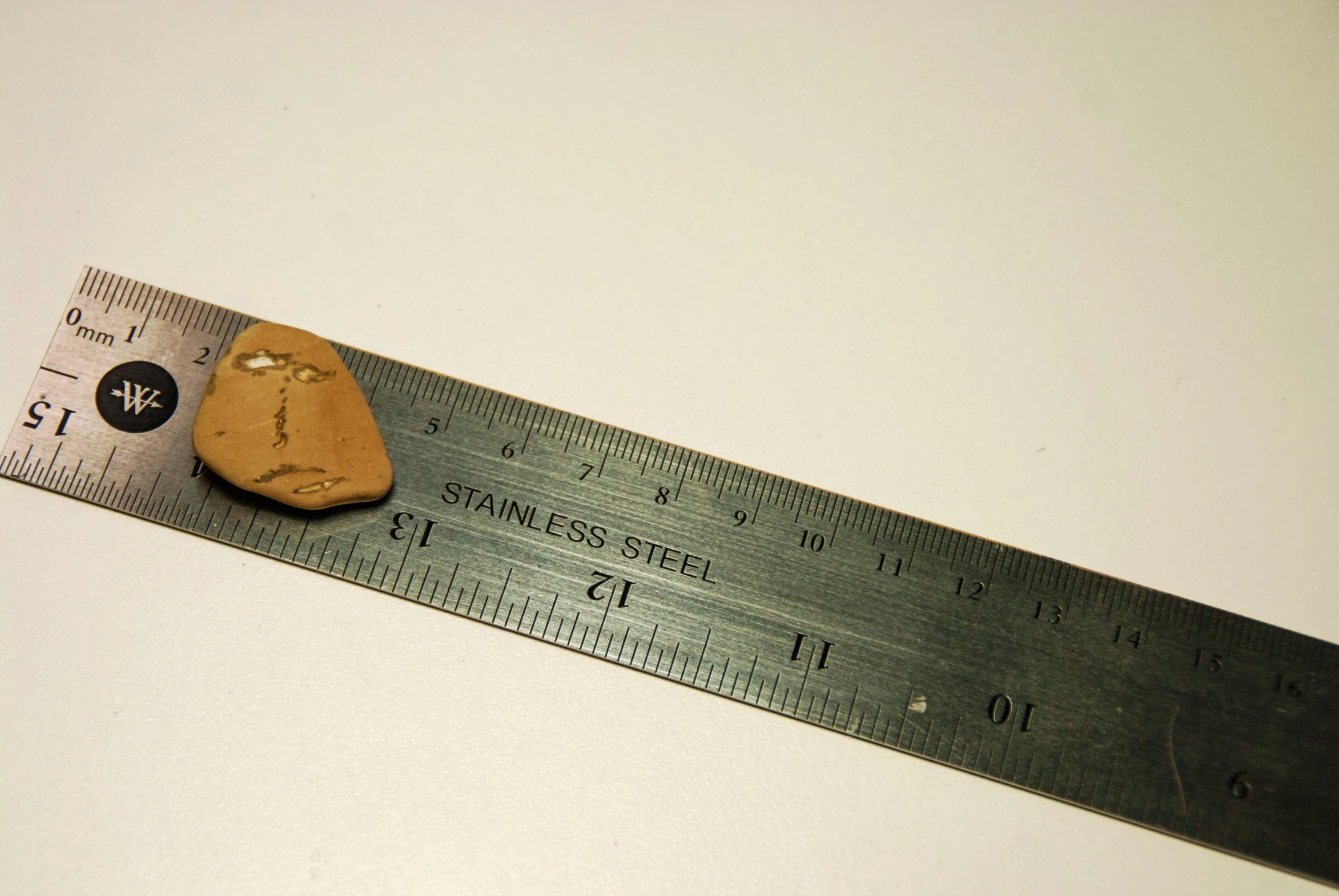 a wooden face on a measuring ruler is a good addition to a class