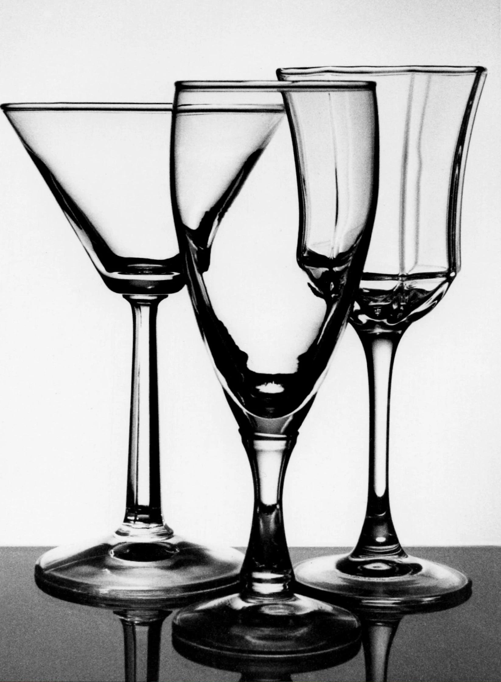 three glasses are shown lined up on the table