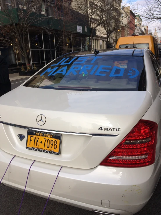 a white mercedes benz w160 taxi parked on the side of the street