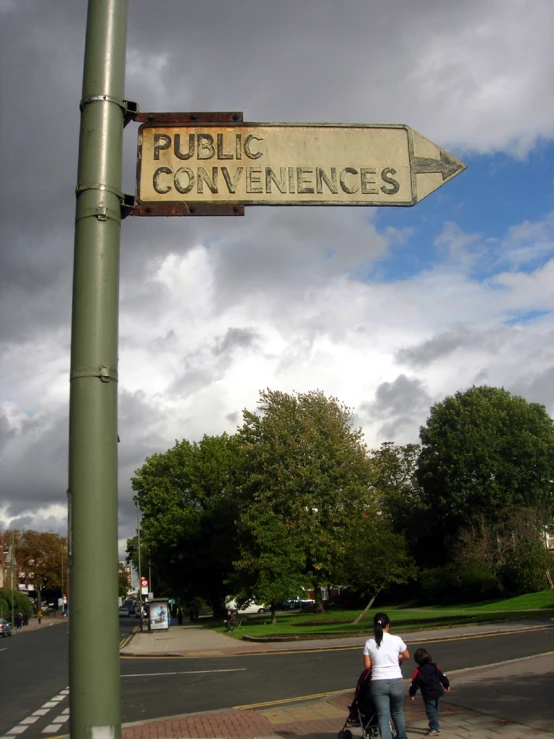 the old public conveniences sign is on the corner of a city street