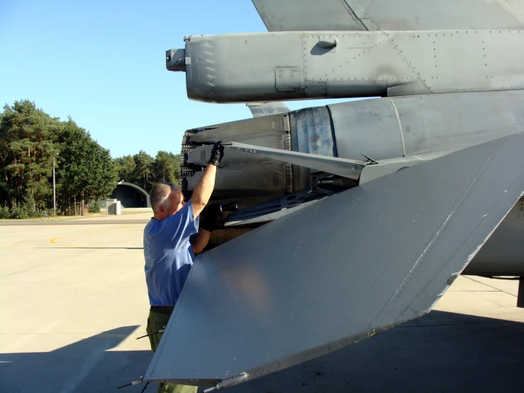 an air force officer is putting the front of a jet