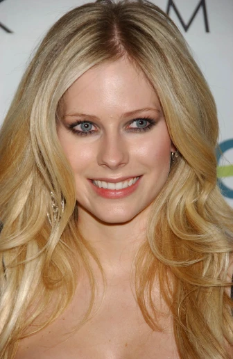a blonde woman with long, curled hair and blue eyes