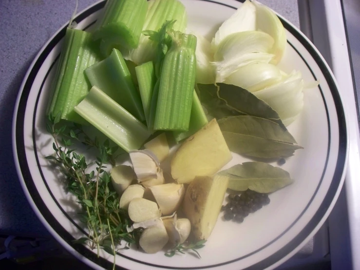 cut up vegetables are sitting on a plate with a knife