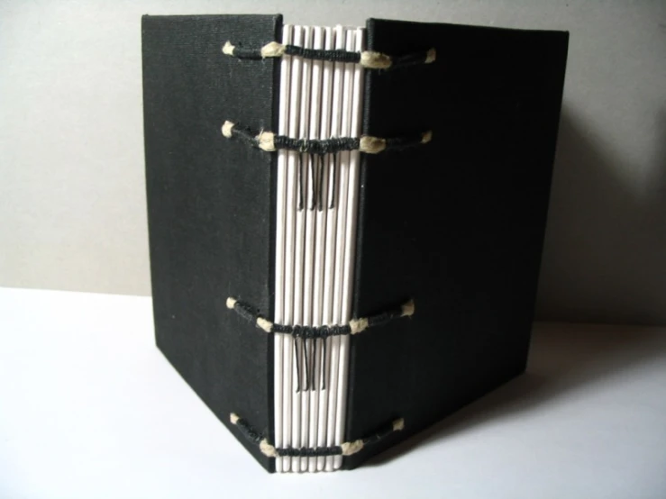 a book cover is attached to a black binding